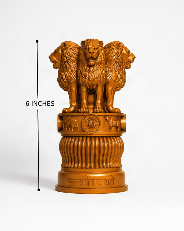 An orange-brown resin statue of the Ashoka Chakra, featuring three lions and a central wheel, displayed on a fluted pedestal. A black vertical line with '6 INCHES' text indicates its height against a clean white background.