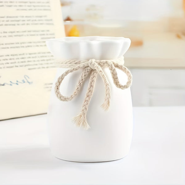 hemp bow  vase with a rope bow on a white surface