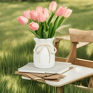 Hemp Bow vase with pink tulips on a table in a grassy outdoor setting
