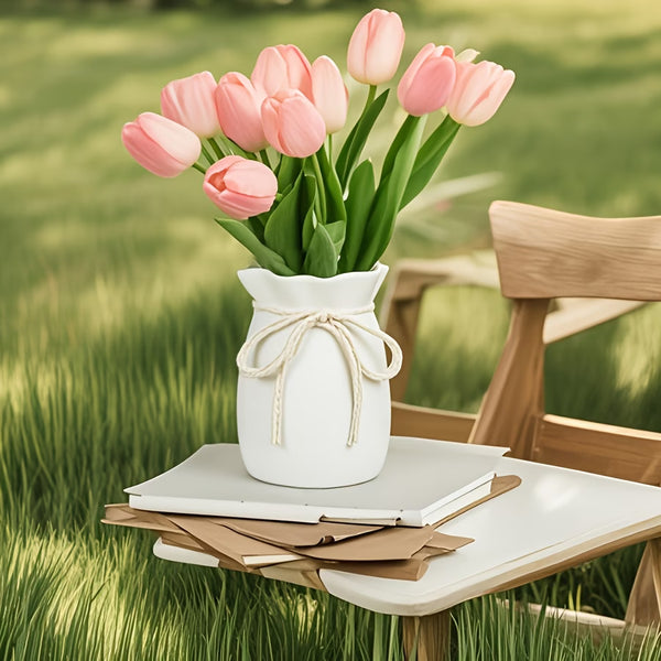 Hemp Bow vase with pink tulips on a table in a grassy outdoor setting