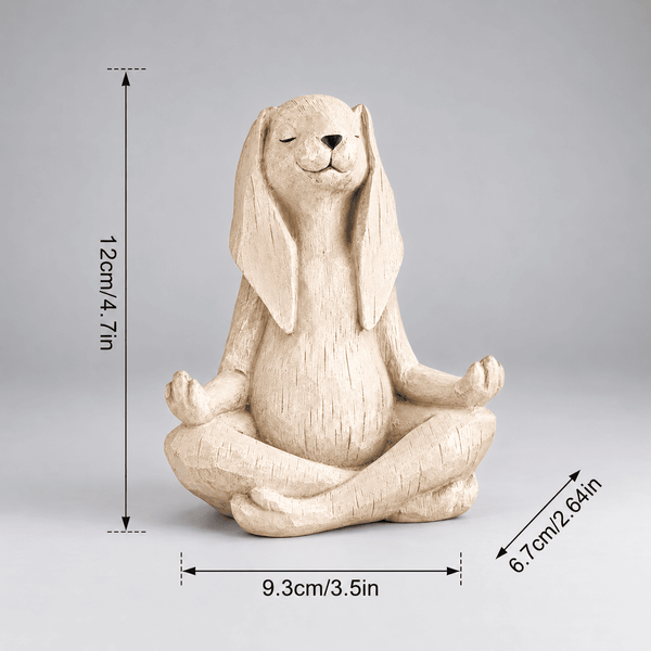 A beige rabbit figurine sitting in a meditative cross-legged pose on a light gray background, with dimension arrows and labels showing height as 12 cm (4.7 in), width as 9.