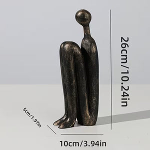 Bronze sculpture of two figures embracing with dimensions indicated on a gray background
