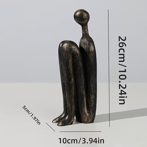 Bronze sculpture of two figures embracing with dimensions indicated on a gray background