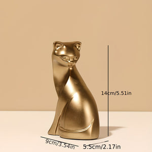 A metallic gold cat figurine shown on a beige background with dimension lines and text indicating its height of 14cm (5.51in), width of 9cm (3.