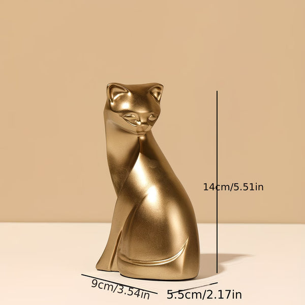 A metallic gold cat figurine shown on a beige background with dimension lines and text indicating its height of 14cm (5.51in), width of 9cm (3.