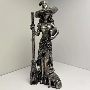 Statue of a witch holding a broom and a cat on a white background decor aura works